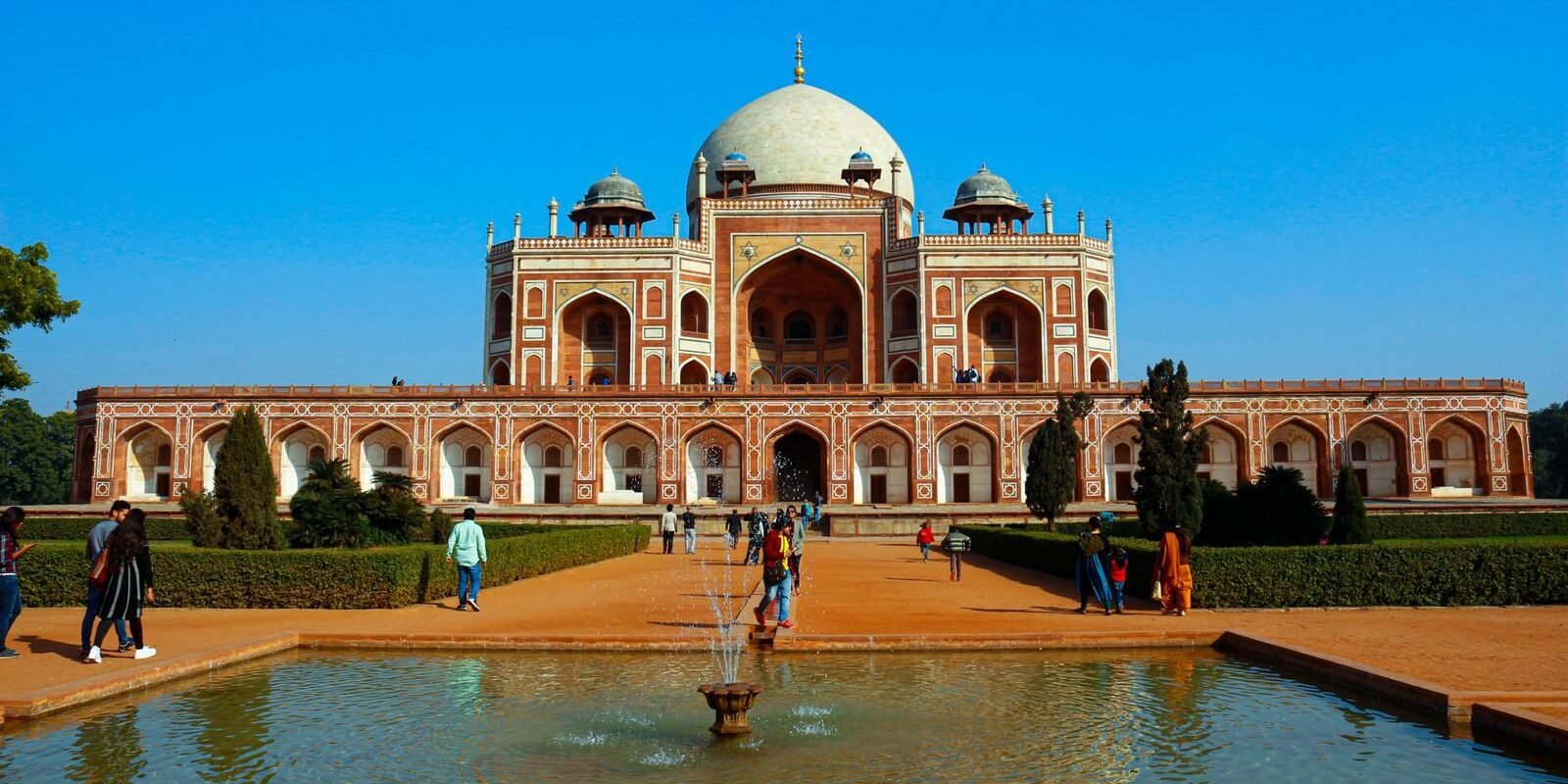 Explore the grandeur of Humayun's Tomb in New Delhi, India, on a bright day with visitors.