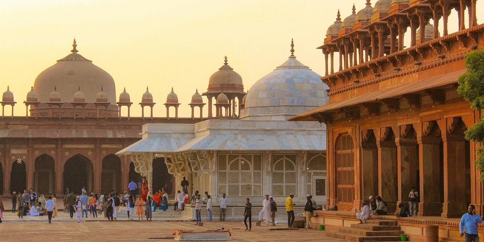 a group of people walking around a courtyard
