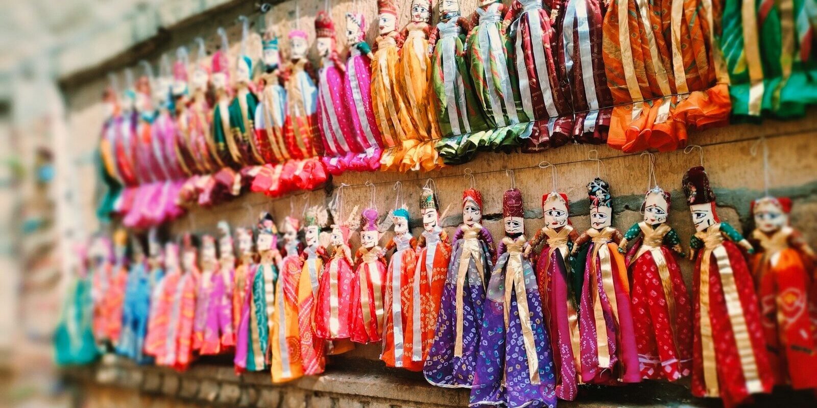 Colorful traditional puppets hanging on a wall